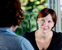 A woman listens to advice from a counselor