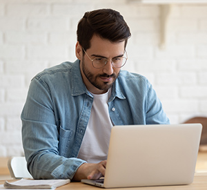 Man taking an assessment on a laptop computer